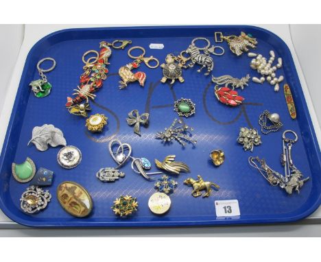 A Selection of Vintage and Later Costume Brooches, including floral inspired; together with seven modern ornate keychains.
