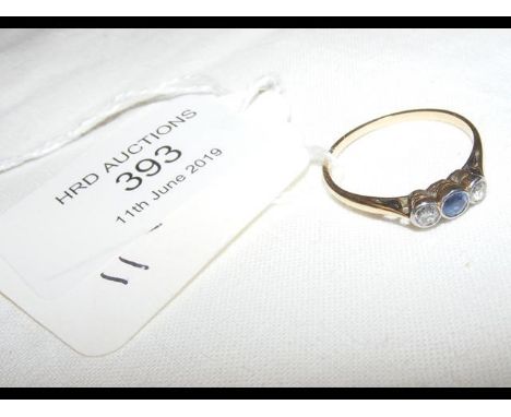 A diamond and sapphire ring in yellow metal setting 