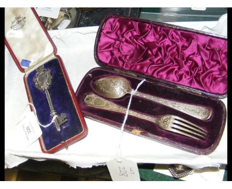 A silver presentation key, together with silver spoon and fork 