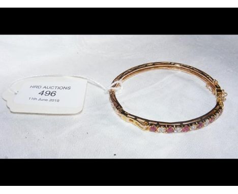 A 9ct gold ruby and cubic zirconia bangle  