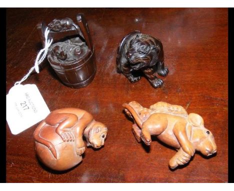 A modern carved wooden netsuke of rats in a barrel, together with three others 