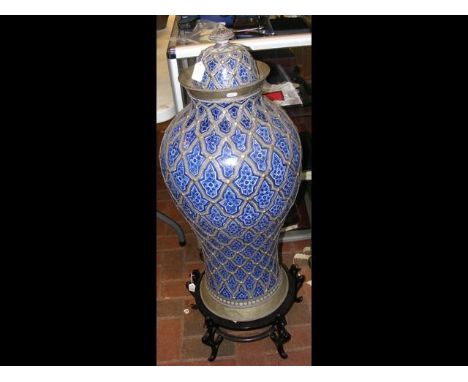 A large Middle Eastern metal and enamel floor vase and cover on wooden stand - 110cm high 