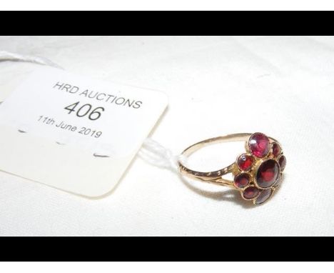 A garnet cluster ring in yellow metal setting 
