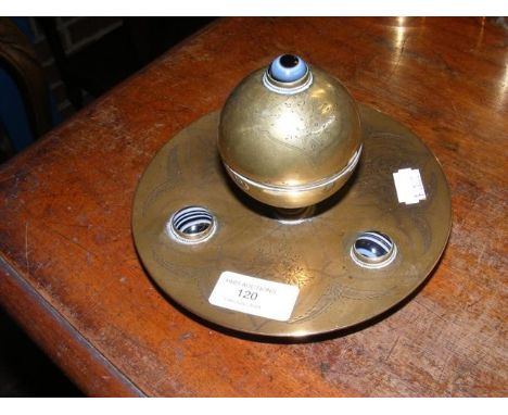 A decorative brass inkwell with cabochon mount  
