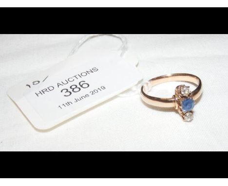 A sapphire and diamond ring in yellow metal setting 
