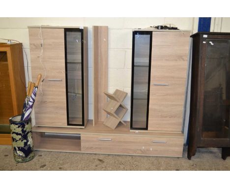 A modern light wood finish suite of lounge furniture with illuminated cupboards