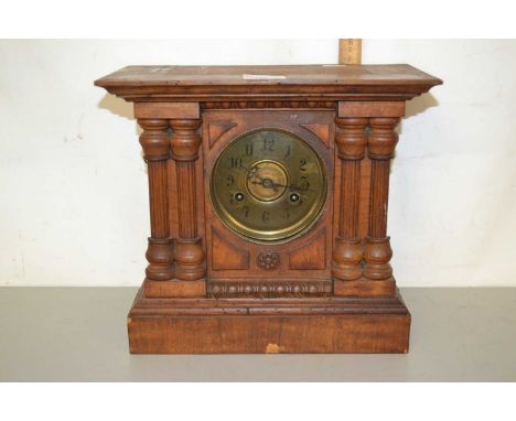 Late 19th Century mantel clock set in an architectural wooden case with pillared decoration