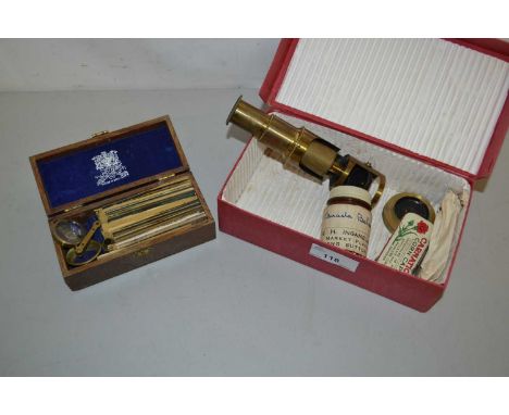 A small brass monocular microscope together with a small quantity of slides