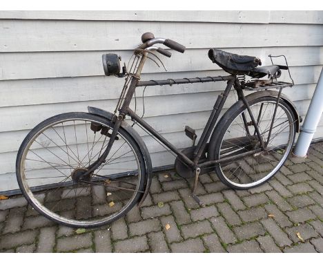 A vintage Raleigh bike with a Pifco front lamp and a spare saddle 