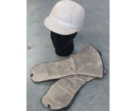 A vintage motorcycle helmet and guantlets