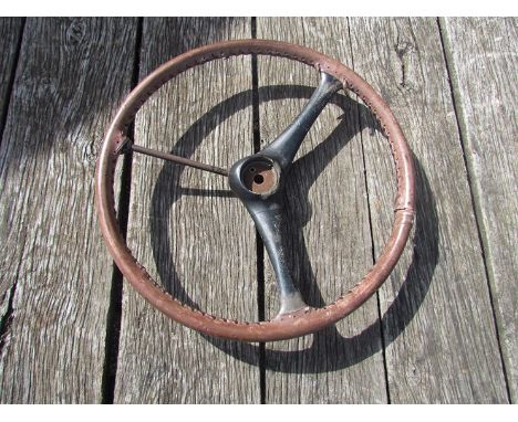 A vintage leather bound metal steering wheel A/F