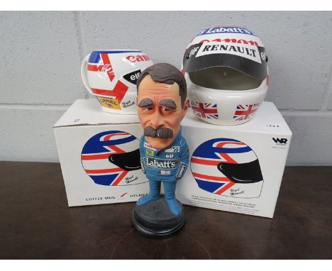 A boxed ceramic Nigel Mansell crash helmet and mug along with a Nigel Mansell figurine 