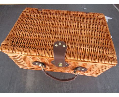 A wicker two person picnic hamper with contents