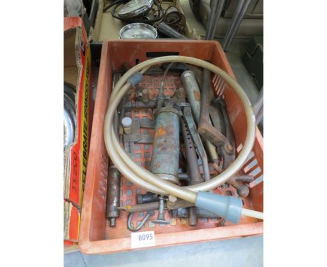 A box of mixed grease guns and tools 