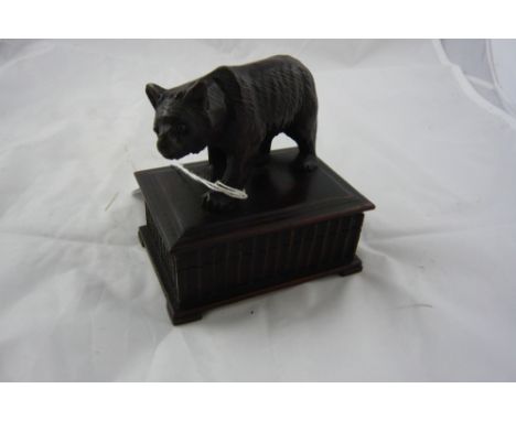 A 19th century black forest carved linden wood trinket box, the top decorated with carved bear, 9cm high