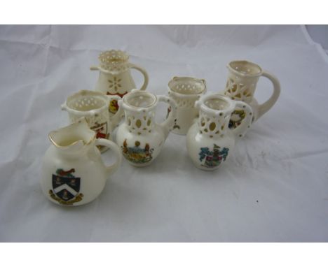 Seven goss crestedware jugs etc. 