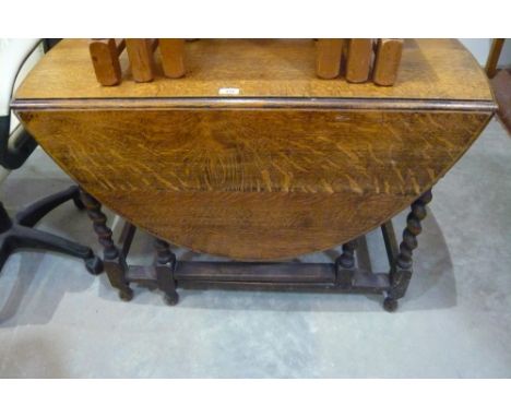 A drop leaf gate leg barley twist oak dining table