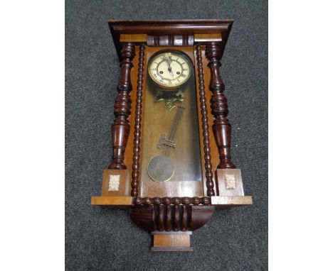 An Edwardian eight day wall clock with pendulum and key 