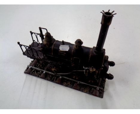 A metal model of a 19th century steam engine on track  