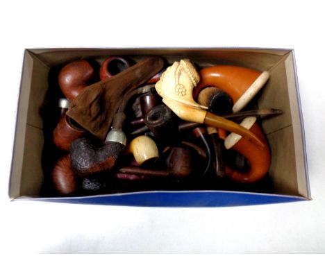 A box containing a collection of vintage pipes  