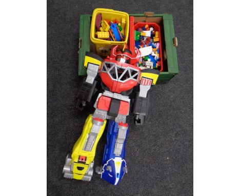 A box containing a bucket of Lego Duplo together with other plastic building blocks, together with a Power Rangers robot 