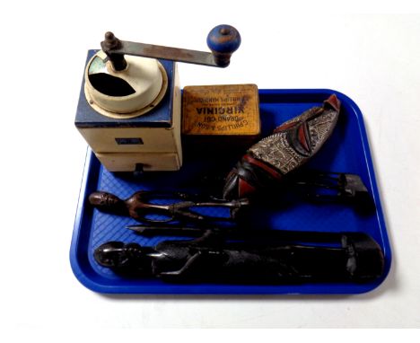 A tray containing vintage Mocca coffee grinder, a Virginia grand cut tin, together with three carved tribal figures and a mas
