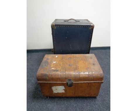 An early 20th century tin trunk together with a further shipping trunk 