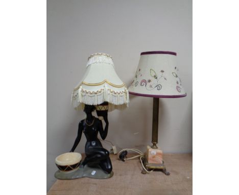 A brass and marble Corinthian column table lamp on paw feet with shade, together with an Art Deco ceramic figural table lamp 