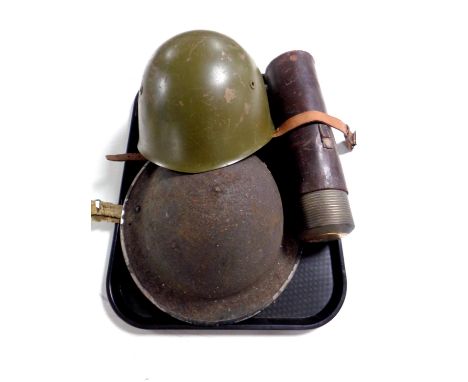 Two World War II tin helmets together with a vintage flask in leather sheath  