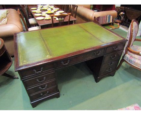 An eight drawer mahogany partners desk with gilt tooled leather top on bracket feet, 151cm x 91cm x 76cm