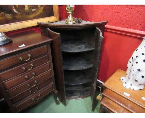 A George III oak bow front two door wall hanging corner cupboard with "H" hinges, curved shelves and fluted pilasters 