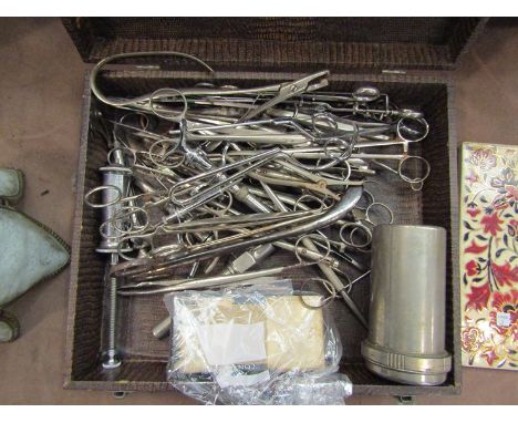 A case containing a quantity of surgeons tools and a boxed syringe    