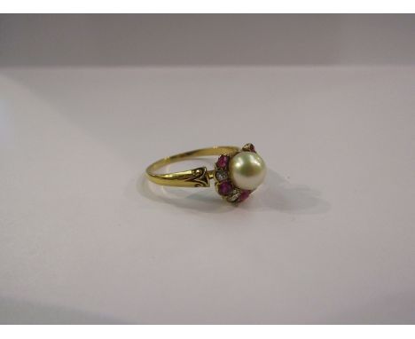 An 18ct ruby and diamond horseshoe ring mounted with central cultured pearl