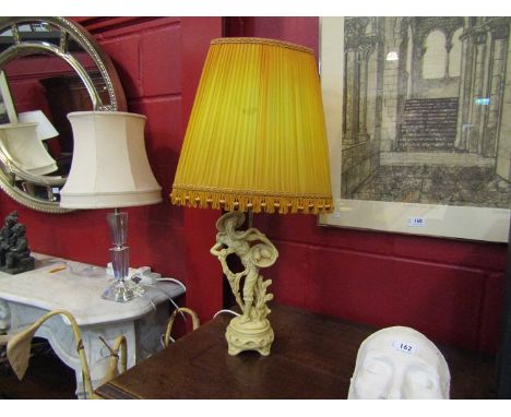 An Oriental figural lamp with silk tasselled shade