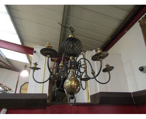 A six branch ceiling light, brass and iron with swirled detailing          