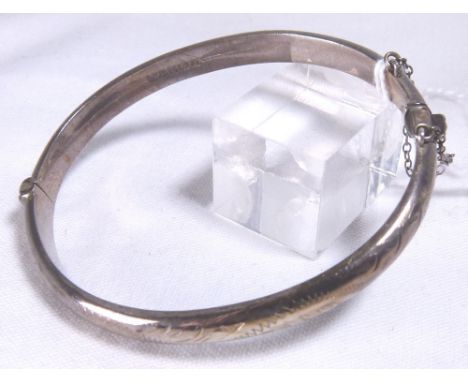SILVER BANGLE. Hallmarked silver bangle with safety chain, assay Birmingham 1967, 10g