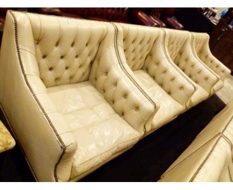 LEATHER ARM CHAIRS. Four Kingstage cream leather button back arm chairs