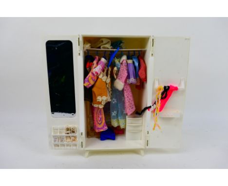 Sindy Pedigree - An unboxed vintage Sindy wardrobe and a collection of clothes and accessories suitable for Sindy. The wardro