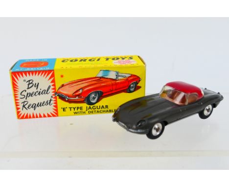 Corgi - A boxed Jaguar E Type in grey with detachable hard top # 307. The car appears in Very Good condition with only light 