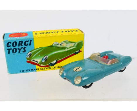 Corgi - A boxed Lotus Mark Eleven Le Mans Racing Car in light blue # 151. The car appears in Very Good condition with light w