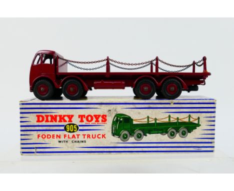 Dinky - A boxed Foden Flat Truck with chains in maroon # 905. The model appears in Very Good condition overall with generally
