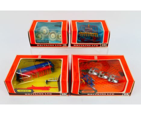 Britains - Four boxed Britains farm implements. Lot consists of Britains #9537 Acrobat Raker; #9543 Buck Rake; #9539 Seed Dri