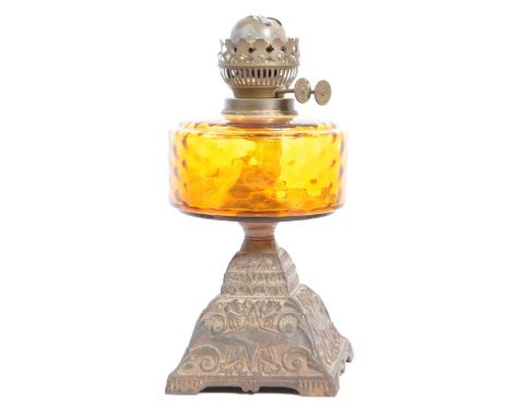 Duplex - A 20th century cast metal and amber glass squat oil lamp by Duplex, Great Britain. The reservoir having an amber col