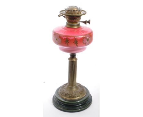 Duplex - A 20th century pressed brass and amber pink glass oil lamp by Duplex, Great Britain. The reservoir having floral dec
