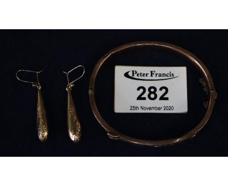 9ct gold buckle bangle and a pair of yellow metal pendant earrings.  Approximate weight 11.7 grams.(B.P. 21% + VAT) 