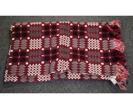 A vintage red ground Welsh tapestry blanket with fringed edging with a 'Made in Mid Wales' label attached. (B.P. 24% incl. VA