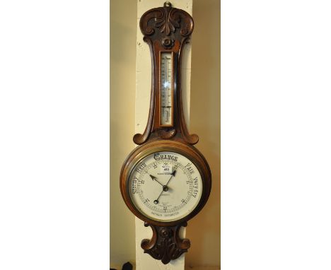Early 20th Century carved walnut aneroid wheel barometer marked Barry & Sons.(B.P. 21% + VAT) 