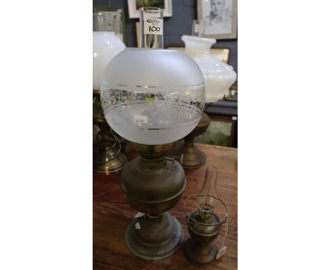 Brass double burner oil lamp with etched glass globe shade and clear chimney, together with a small brass oil lamp. (2)(B.P. 