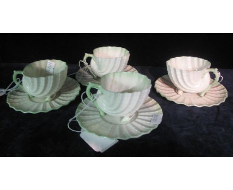 Set of four Belleek Irish porcelain conical conch shell shaped cabinet cups and saucers with black transfer printed marks to 