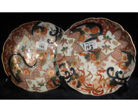 Pair of Japanese porcelain Imari design wave edged shallow dishes, overall with floral and stylised geometric patterns in und